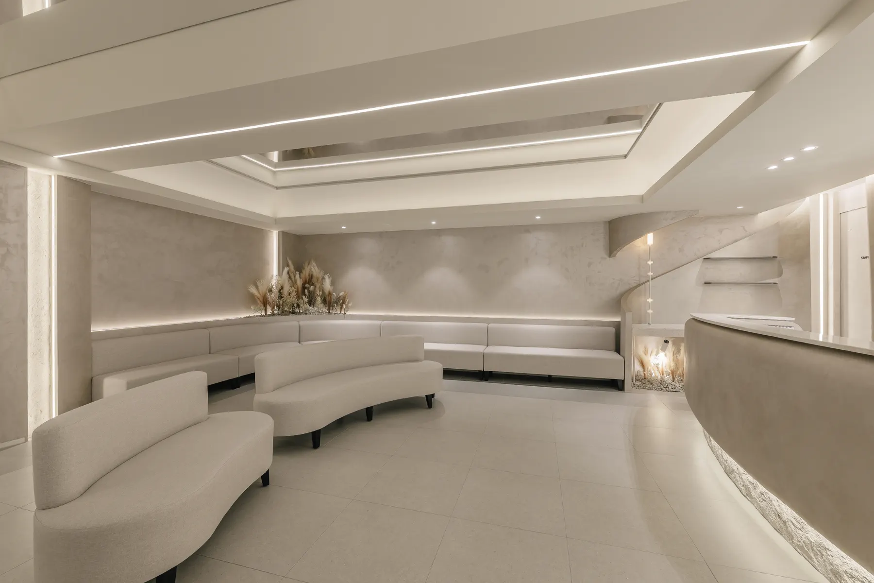 Waiting lounge with curved cream sofas and dried pampas grass at THE Beautiful Clinic in Seoul