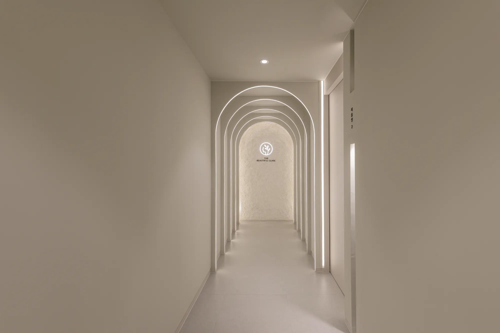 Arched limestone corridor inside THE Beautiful Clinic in Nonhyeon, Seoul