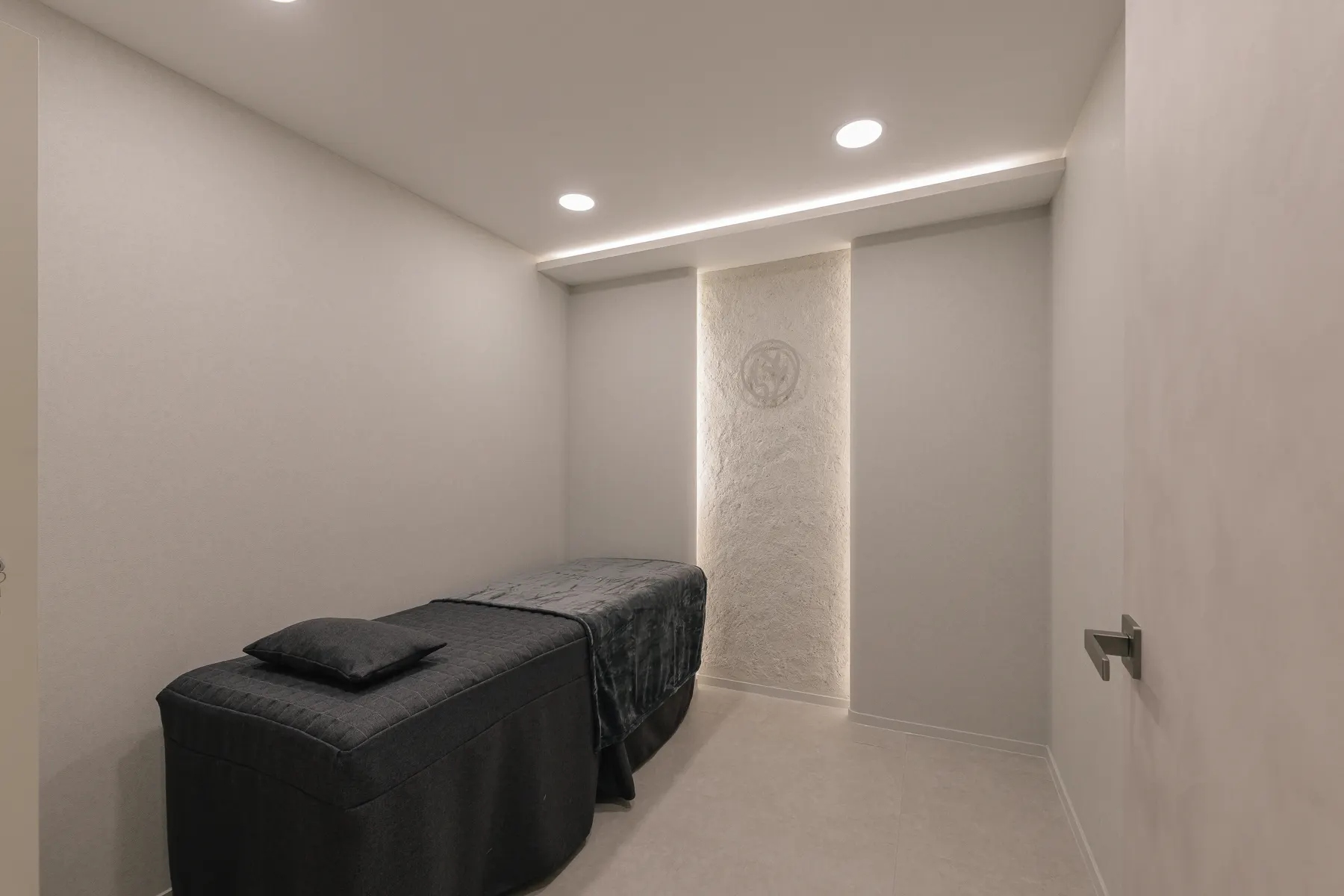 Private treatment room with a bed and equipment at THE Beautiful Clinic in Seoul